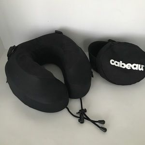 Cabeau memory foam neck pillow attaches to airplane seat headrest.